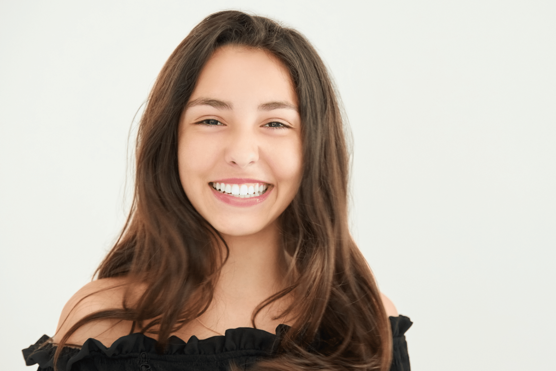Smiling young woman displaying a bright, straight, white smile
